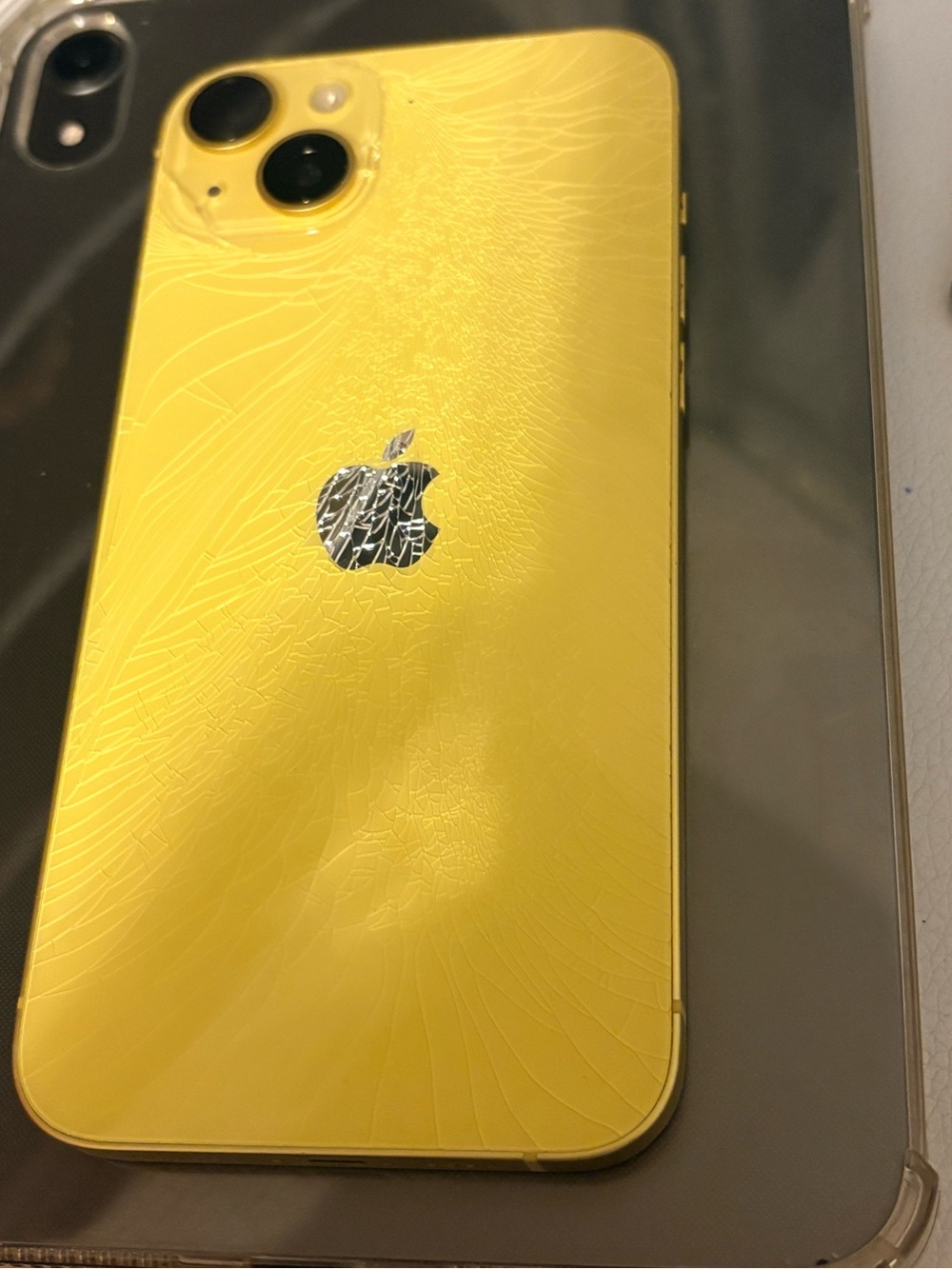 Apple Yellow iPhone with Cracked Back Panel